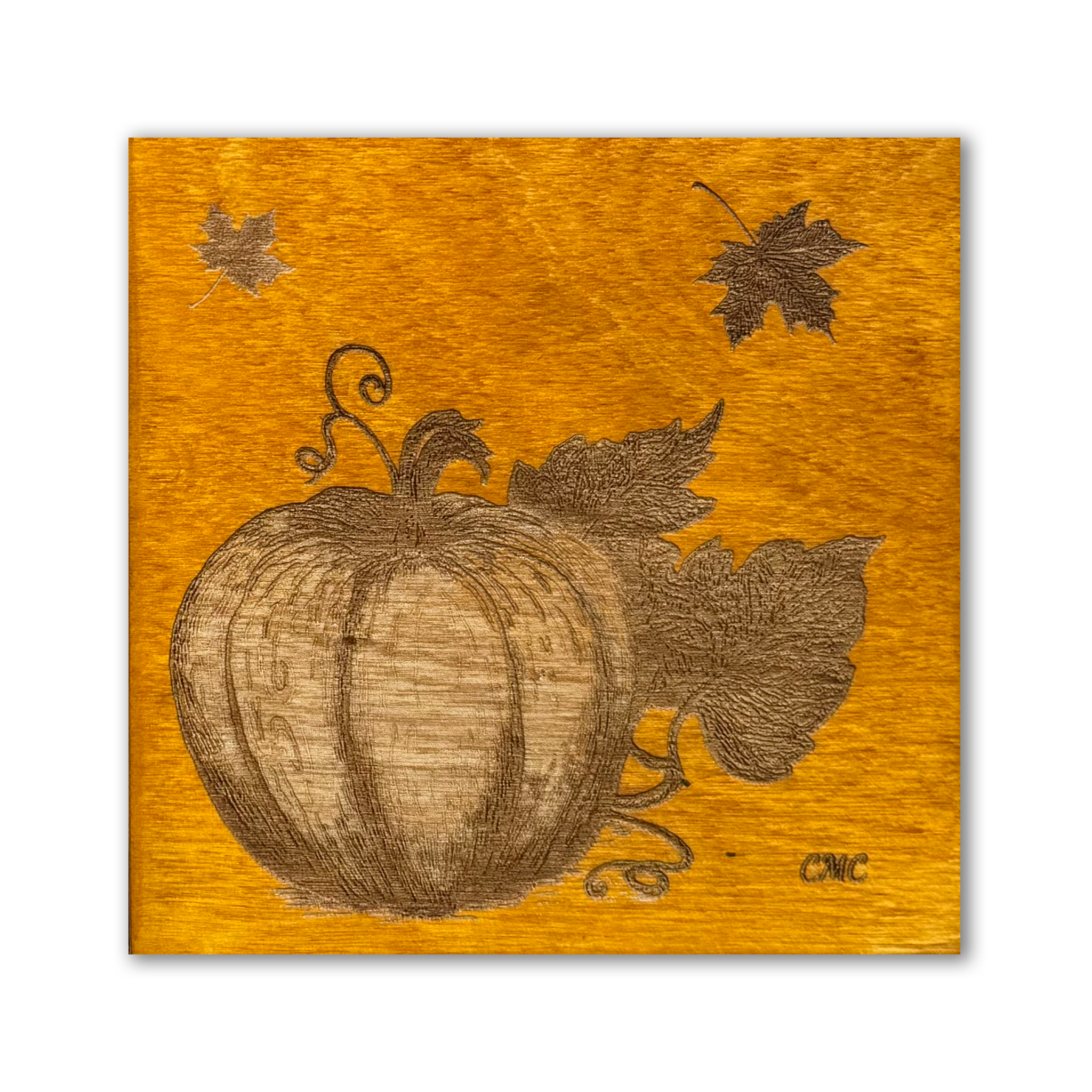 Laser engraved pumpkin on an amber coloured baltic birch tile